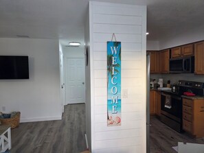 A modern kitchen with wooden cabinets, a microwave, and a stove. - 3 Minutes to Anna Maria Island. Boat, RV & Jet Ski Parking + Large Private Yard (Bradenton)