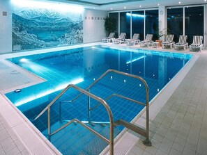 An indoor swimming pool with a view of a mountainous landscape, lounge chairs, and a tiled floor. - 2 Person Holiday Park Home in Garmisch-partenkirchen (Garmisch-Partenkirchen)