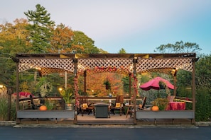 A gazebo with a lattice roof, seating area with chairs and a table, and string lights. - Large 1BR Suite with Full Kitchen (Blowing Rock)