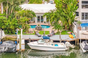 A boat docked at a marina with a pool and lounge chairs in the background. - Amazing property next to Las Olas Boulevard (5 min) (Fort Lauderdale)