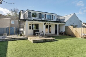 A two-story house with a patio, a fenced yard, and a wooden deck. - 1 Bedroom Apartment Sleeps 2 - Pets Welcome (St. Ives)