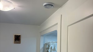 A bathroom with a shower curtain, a ceiling light, and a framed picture on the wall. - The Pearl of Dieppe (Dieppe)