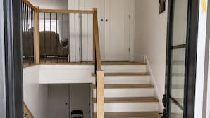 A staircase leading to a second-floor bedroom with a door at the top. - The Pearl of Dieppe (Dieppe)