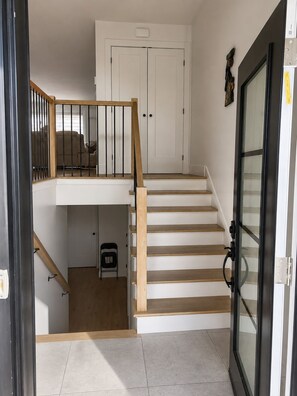 A staircase leading to a second-floor bedroom with a door at the top. - The Pearl of Dieppe (Dieppe)