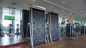 A gym with treadmills, stair climbers, and a climbing wall. - Luxurious 1BR condo in prime Location (Miami)