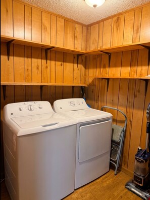 A laundry room with two stacked washers and a vacuum cleaner. - Soothing 3-bedroom house with AC in charming Gaffney (Gaffney)