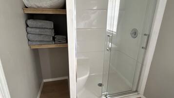 Shower, hair dryer, towels, soap