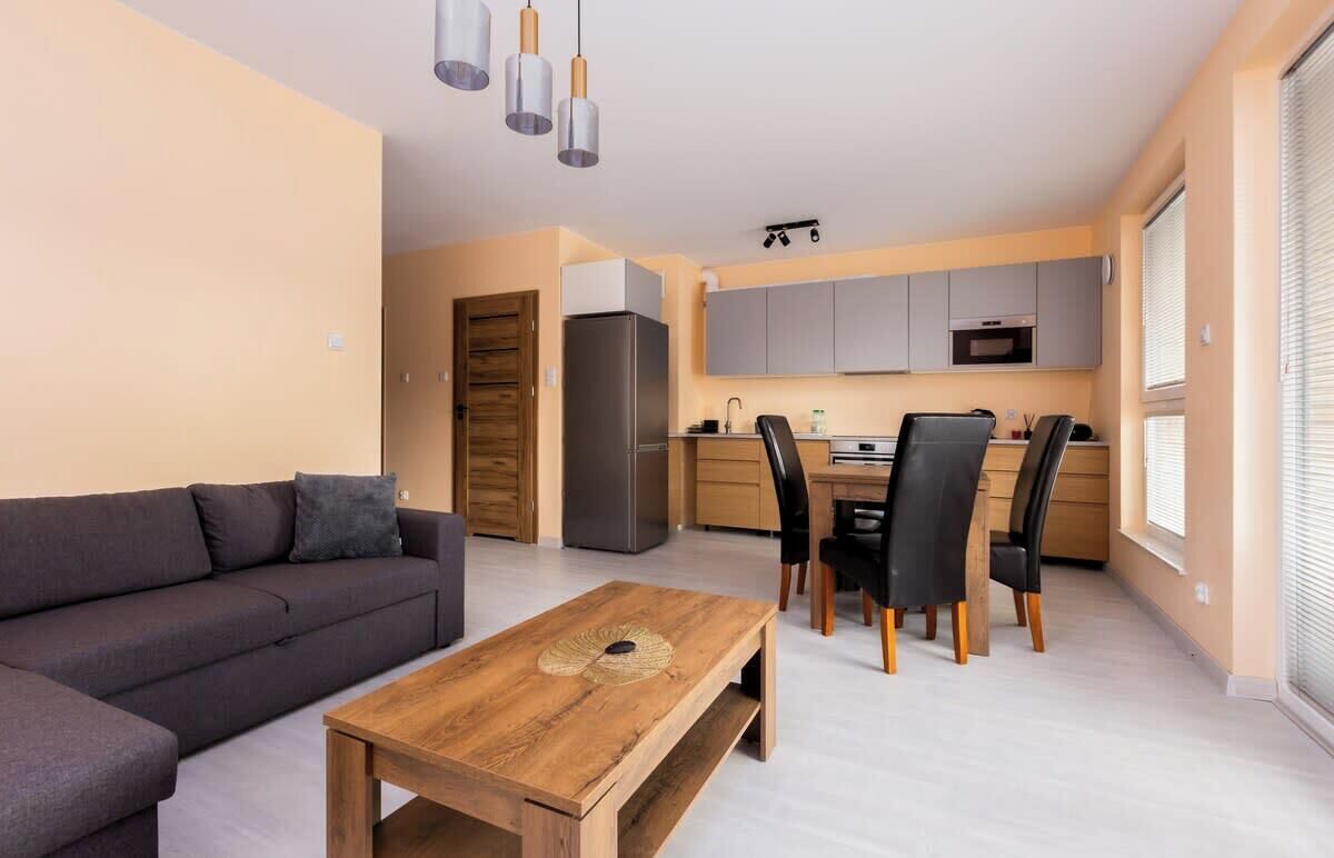 A modern apartment with a living area, dining space, and kitchen.
