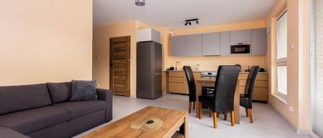 A modern apartment with a living area, dining space, and kitchen.