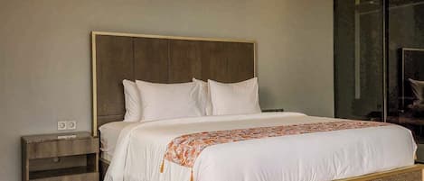A modern bedroom with a wooden headboard, a bed with white linens, and a nightstand with a lamp.