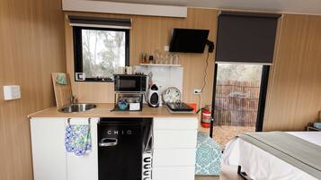 A compact kitchen with a microwave, toaster, and coffee maker.