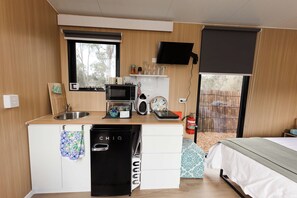 A compact kitchen with a microwave, toaster, and coffee maker.
