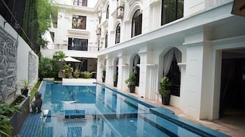 Outdoor pool, open 9:00 AM to 9:00 PM, pool umbrellas, pool loungers