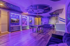 A room with a pool table, a sofa, and a ceiling fan. - 14-bedroom house in Davenport close to Disney animal kingdom. (Davenport)
