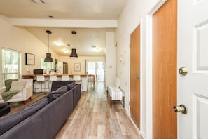 A modern interior with a living area, kitchen, and dining space.