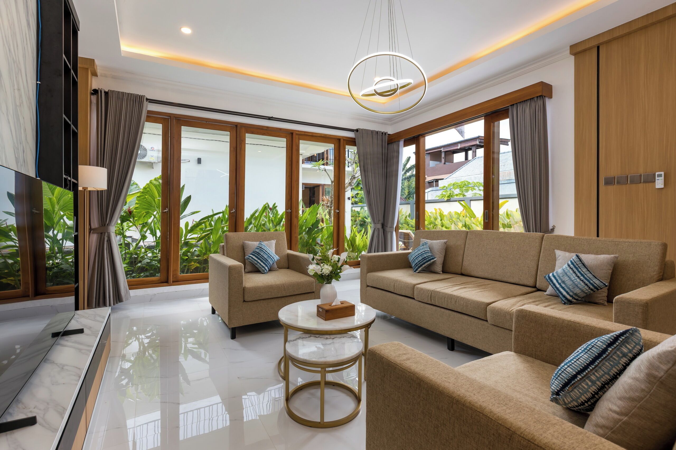 A modern living room with a sofa set, a coffee table, and a TV.