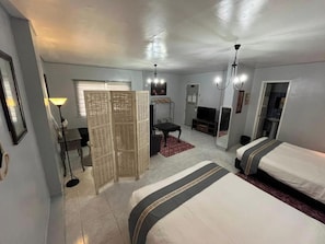 A hotel room with two beds, a desk, a chair, a television, and a wardrobe. - Sunbloom Beach Resort (Candelaria)