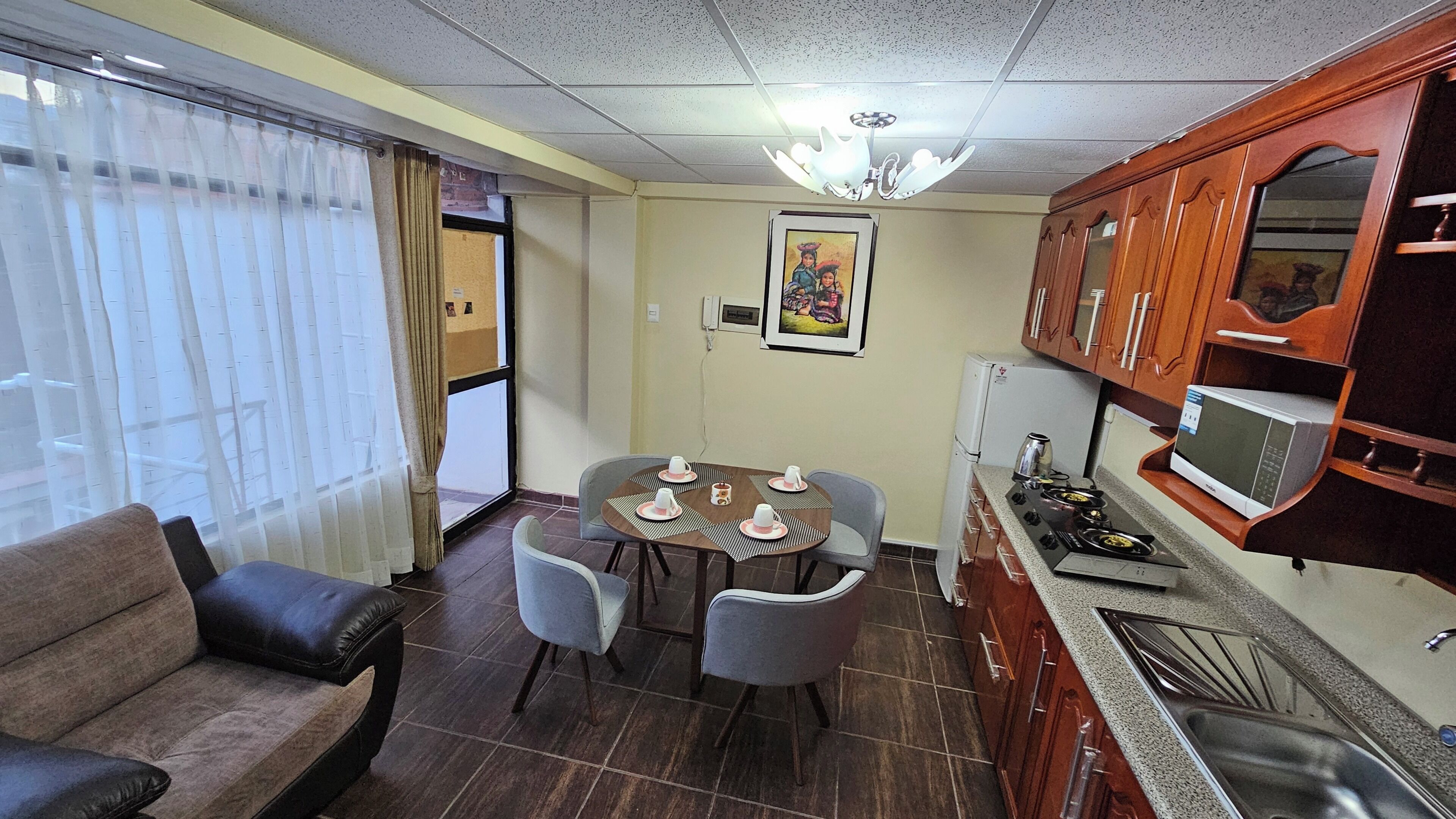 A compact living space with a dining area, kitchenette, and seating.