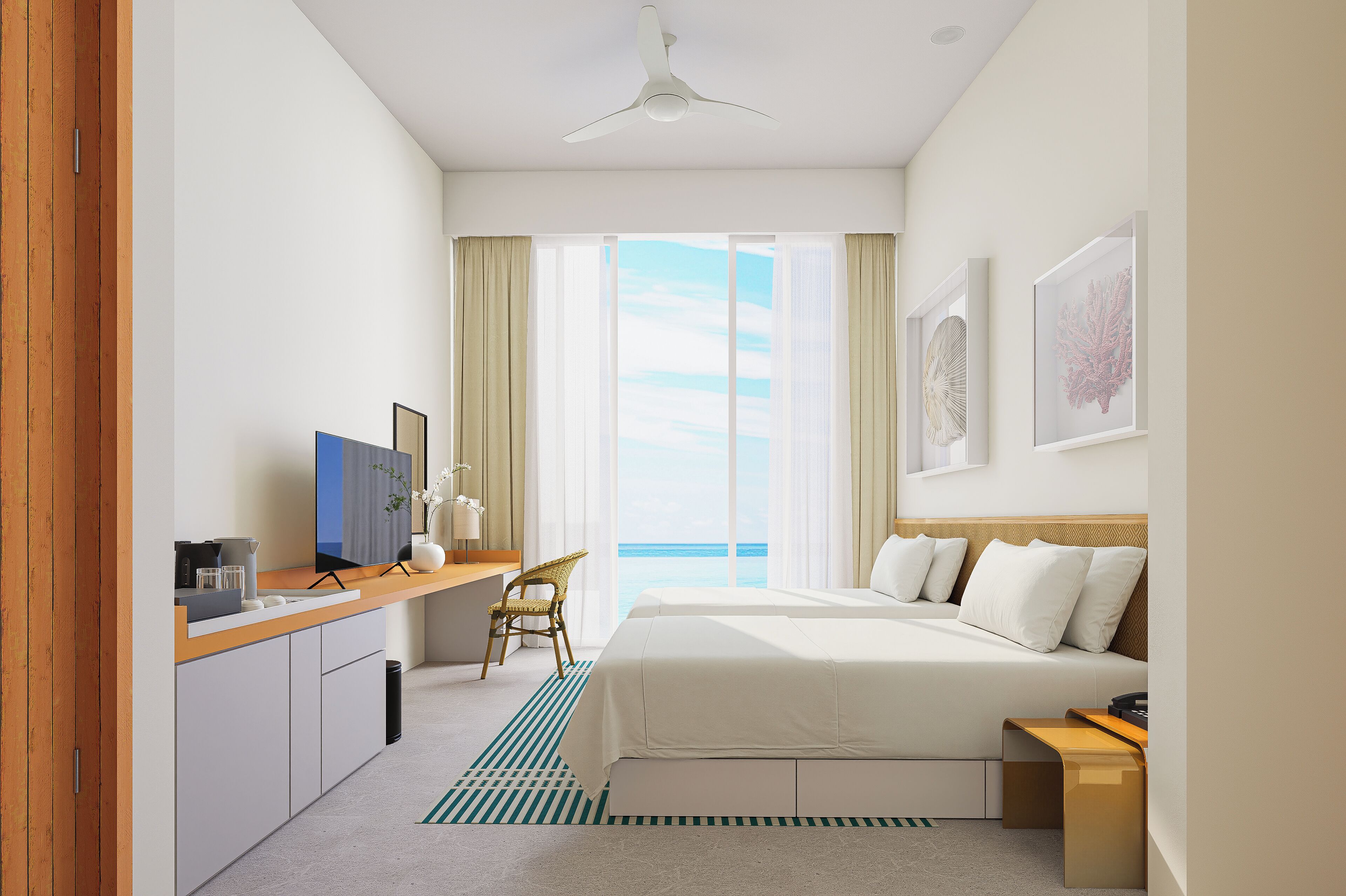 Habitación de hotel con cama, escritorio, silla, televisor y vista al océano.