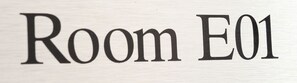 A sign with the text 'Room E01'.