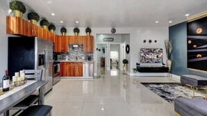 A modern kitchen with wooden cabinets, stainless steel appliances, and a central island. - Glamorous 2Bed/2Bath/2K- 5★ DT Location-♛Hot Tub (Fort Lauderdale)