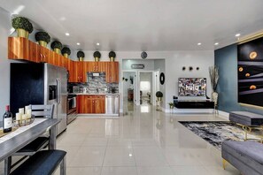 A modern kitchen with wooden cabinets, stainless steel appliances, and a central island. - Glamorous 2Bed/2Bath/2K- 5★ DT Location-♛Hot Tub (Fort Lauderdale)