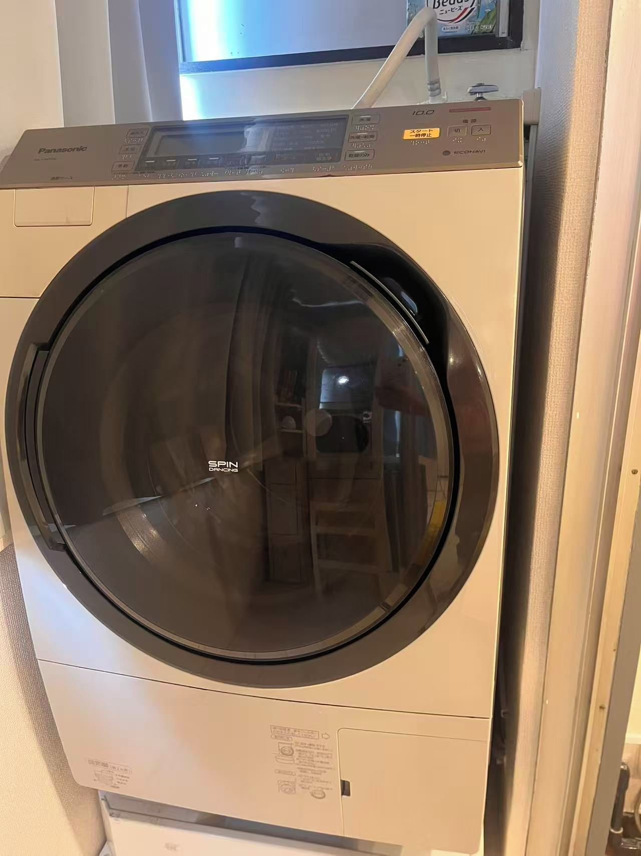 A front-loading washing machine with a control panel and a transparent door.