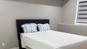 A bedroom with a bed, a headboard, and a window with blinds. - 5 Bedrooms deluxe, Hyde Park Mall and Western University area Sleep up to 10 (London)
