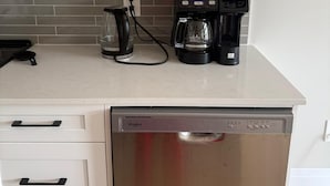 A kitchen with white cabinets, a coffee maker, and a dishwasher. - 5 Bedrooms deluxe, Hyde Park Mall and Western University area Sleep up to 10 (London)