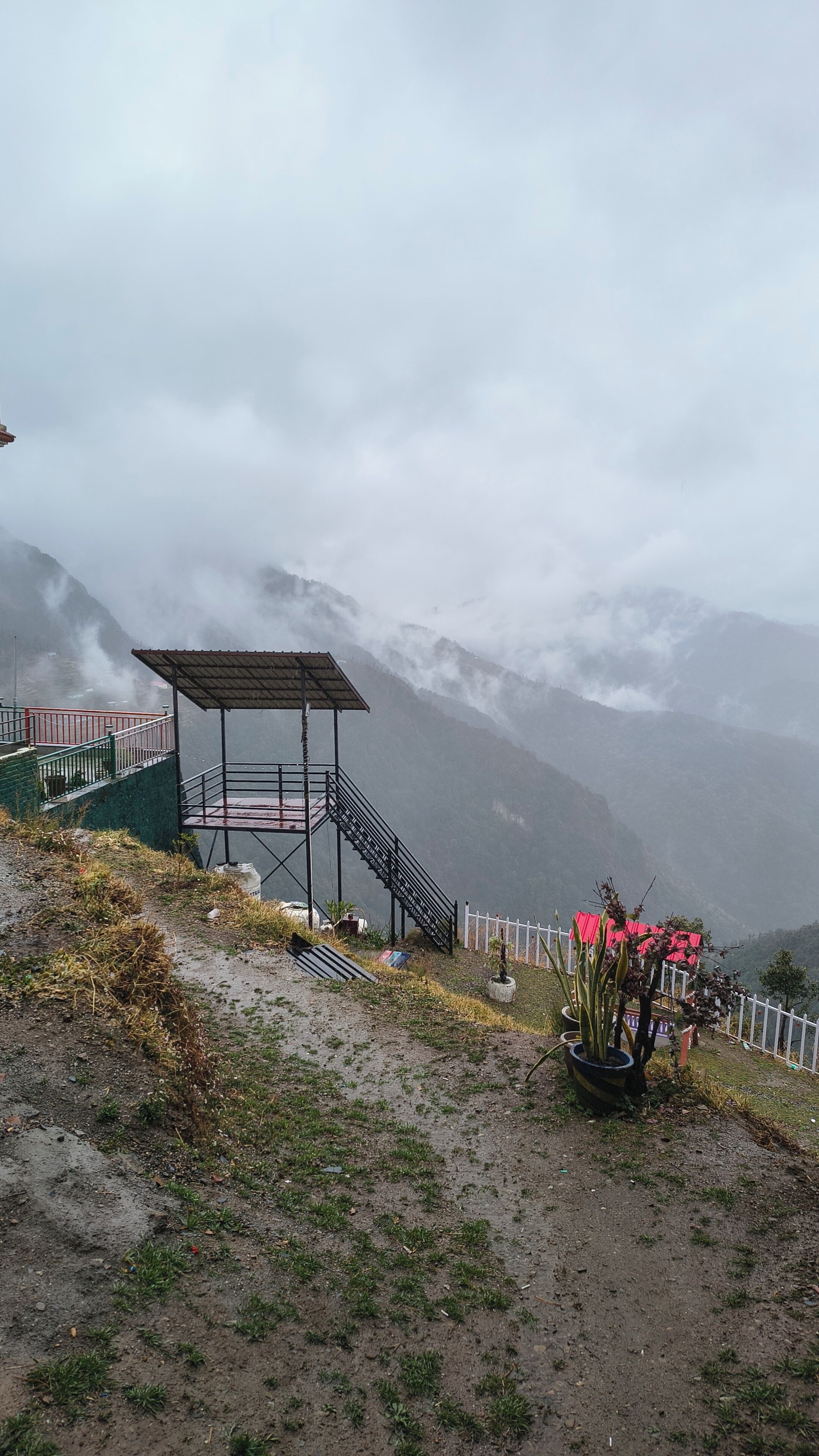 A mountainous landscape with a viewing platform and a staircase leading up.