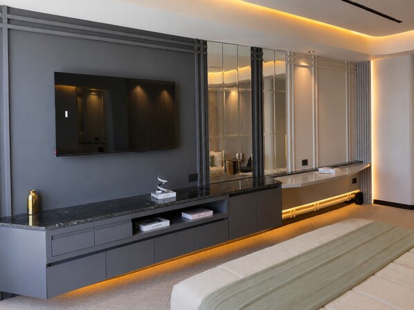 A modern bathroom with a large mirror, a vanity with drawers, and a bench.