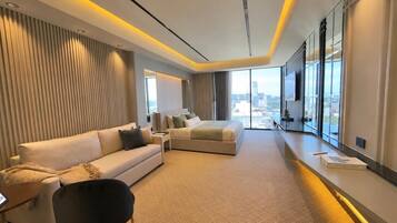 Suite Deluxe, vista a la ciudad | Área de sala de estar