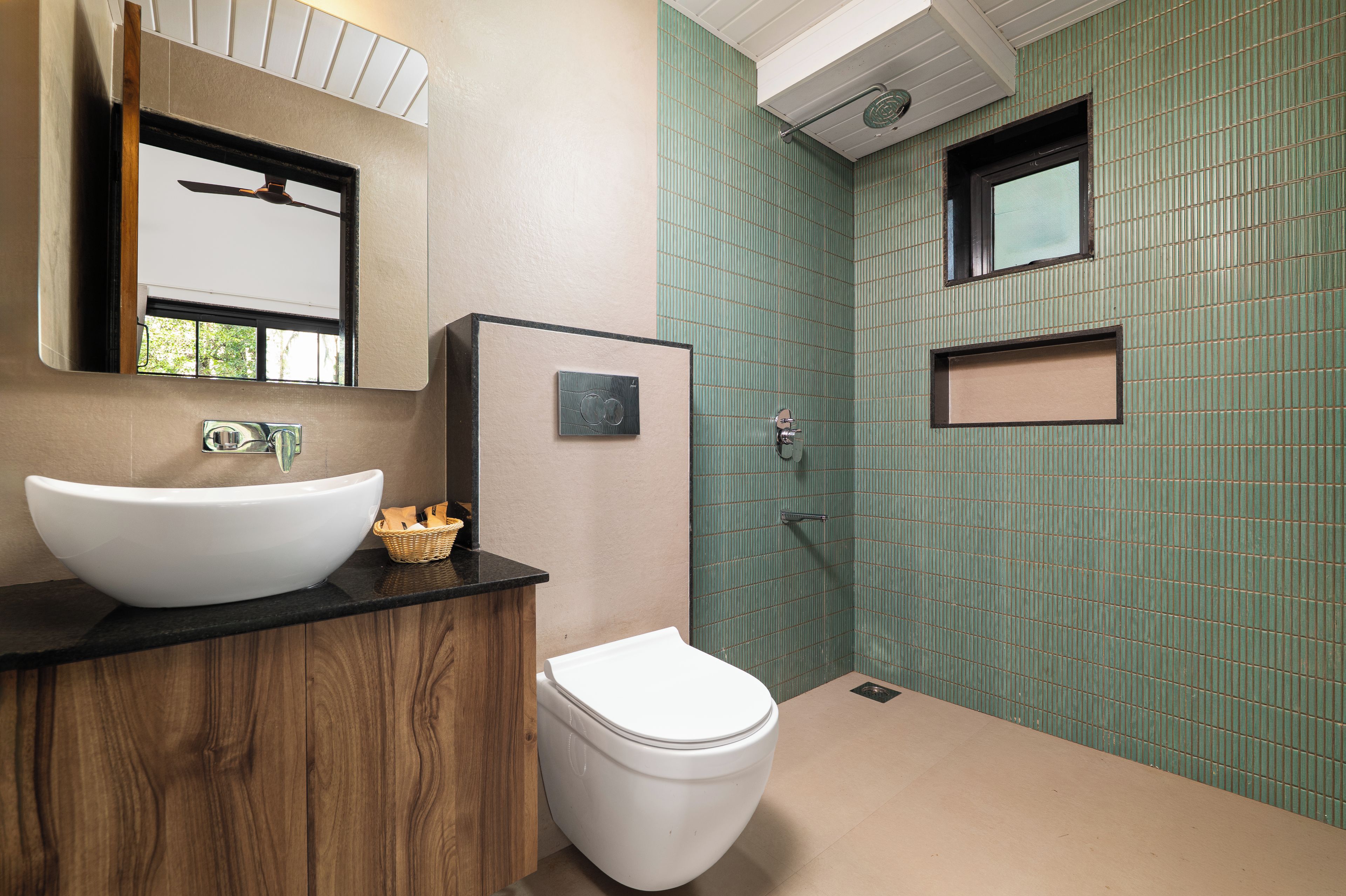 A bathroom with a white sink, a toilet, and a shower area.