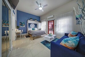 A modern living room with a bed, a sofa, a coffee table, and a desk. - Stylish Studio Oasis - Walk to Downtown - ♛Hot Tub (Fort Lauderdale)