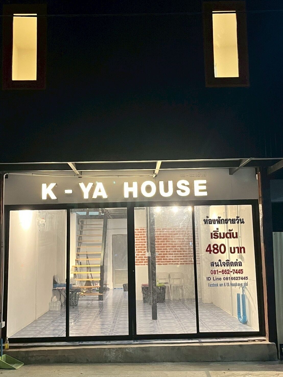 A building with a sign reading 'K-Ya House' and a contact number.