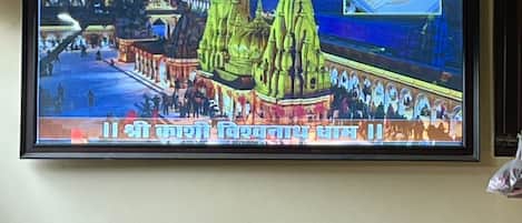 A television displaying a temple with multiple spires and a crowd of people.