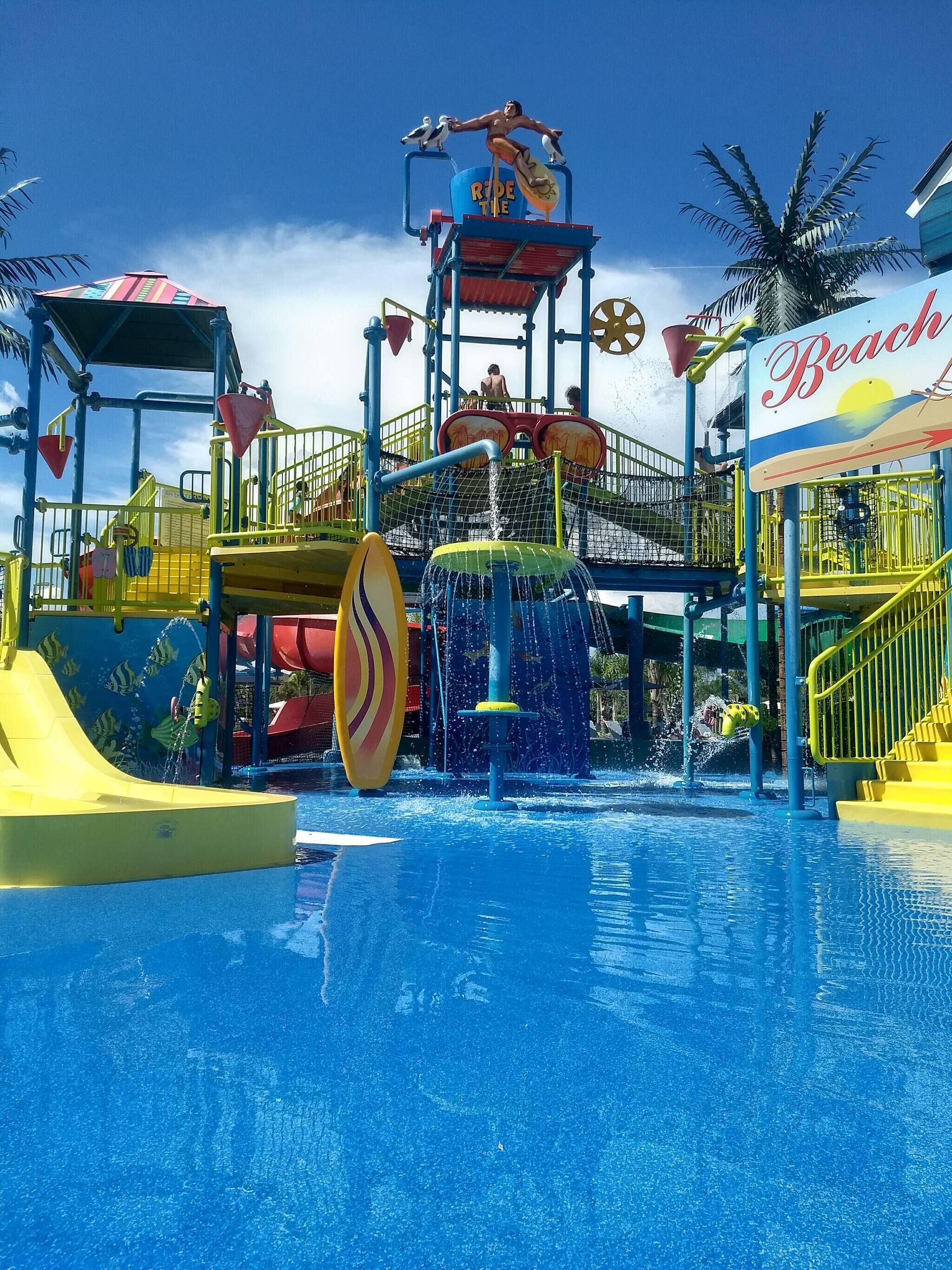Un parc aquatique doté d’une grande piscine, de toboggans et d’une attraction appelée « Prenez la vague ».