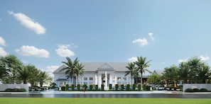 A large, two-story building with a symmetrical facade, a central entrance with columns, and a fountain in the foreground. - Metropolo Jinjiang Hotels Luang Prabang (Luang Prabang)