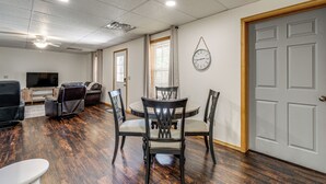 A living room with a dining table, chairs, a sofa, and a television. - 8 Mi to Nat'l Military Park: Rural Pea Ridge Base (Pea Ridge)