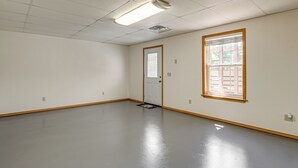 A room with a door, a window, a light fixture, and a floor. - 8 Mi to Nat'l Military Park: Rural Pea Ridge Base (Pea Ridge)