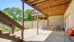 A covered patio area with a wooden ceiling, outdoor furniture, and a brick wall. - 8 Mi to Nat'l Military Park: Rural Pea Ridge Base (Pea Ridge)