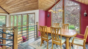 A dining area with a wooden table and chairs, large windows, and a wooden ceiling. - Fire Pit & Wildlife Views! Tranquil Bend Retreat (Bend)