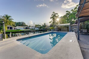 A rectangular swimming pool with a tiled edge, surrounded by a concrete deck. - 3 Mi to Hollywood Beach! Canal-Front Haven w/ Dock (Hollywood)