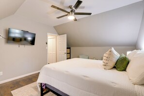 A bedroom with a bed, pillows, a ceiling fan, a TV, and a door. - Group Entertainment Oasis! 3-Unit Lithonia Getaway (Lithonia)