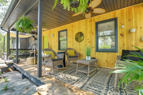 A covered porch with wicker furniture, a ceiling fan, and a wooden wall. - Group Entertainment Oasis! 3-Unit Lithonia Getaway (Lithonia)