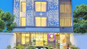 A modern hotel with a prominent sign, multiple floors, and a well-lit entrance. - Cozzet Yashobhoomi Dwarka (New Delhi)