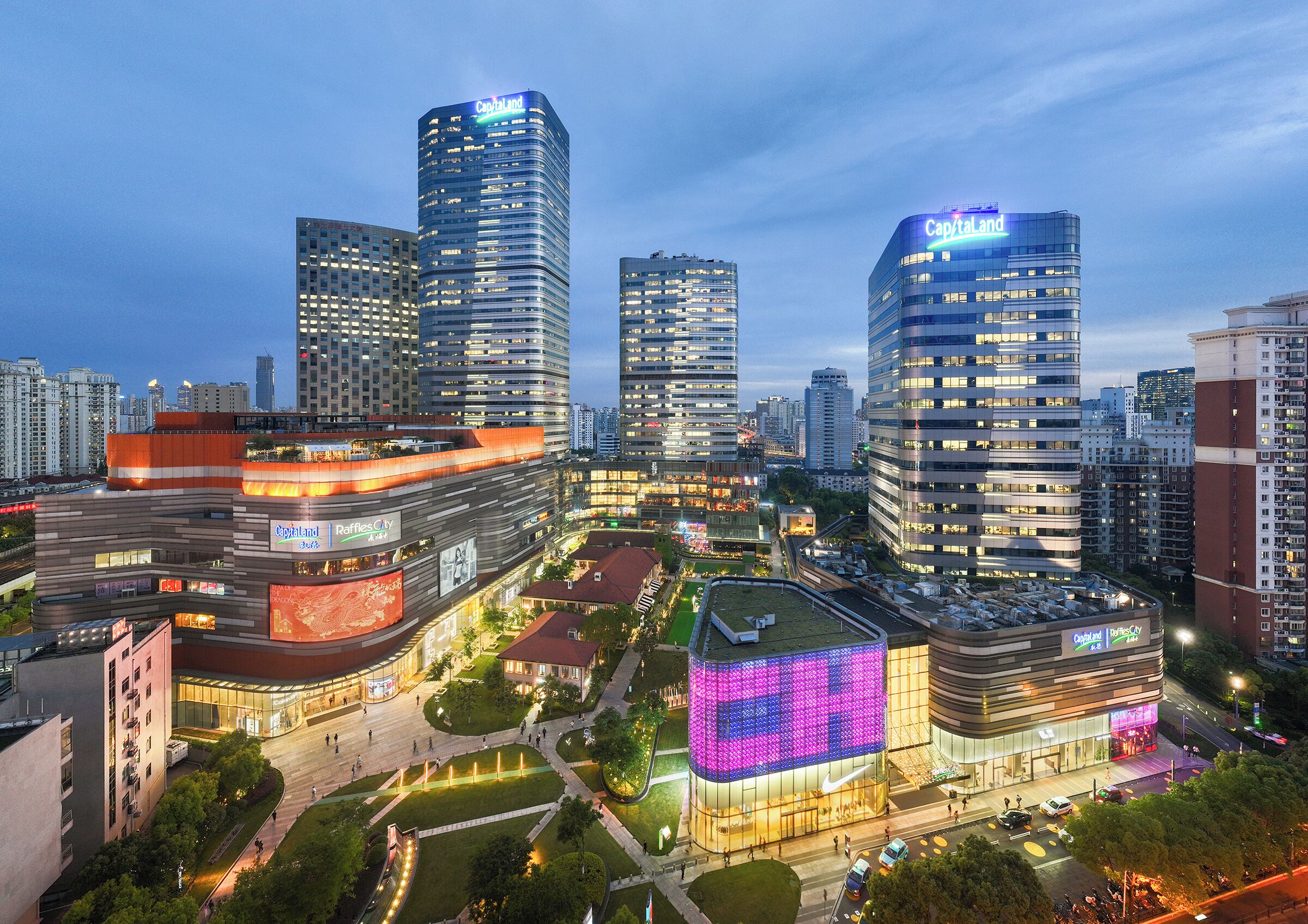 A cityscape with modern high-rise buildings, including a prominent CapitalLand building.