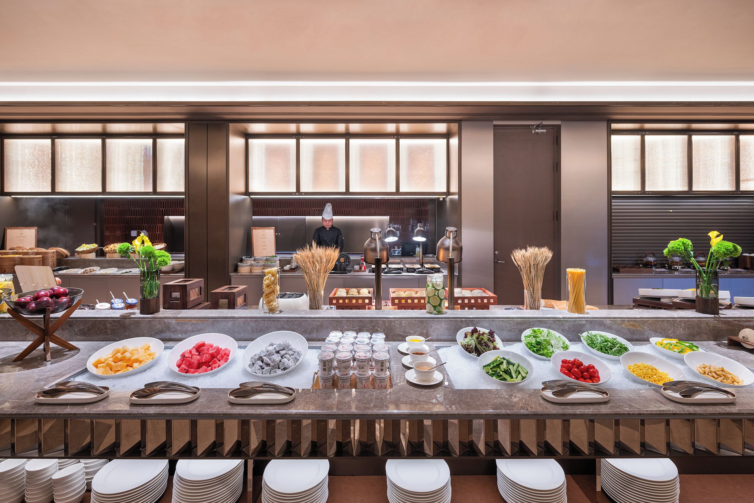 A buffet setup with various food items and condiments.