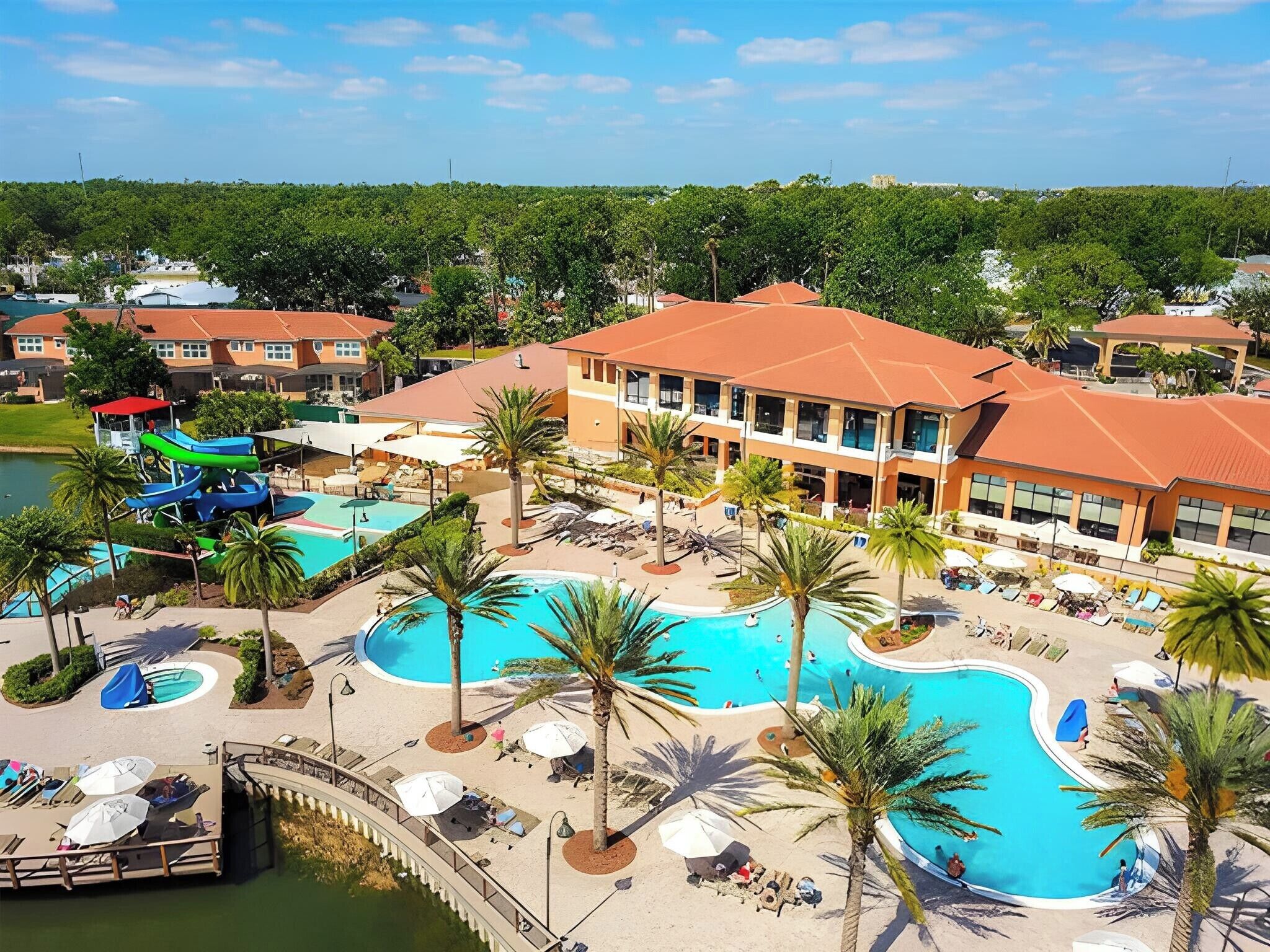 A resort with a large central pool, multiple smaller pools, and a water slide.