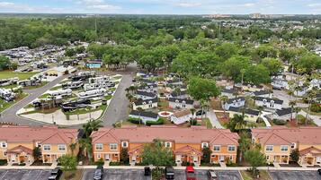 A residential area with single-family homes, a parking lot, and a row of mobile homes.